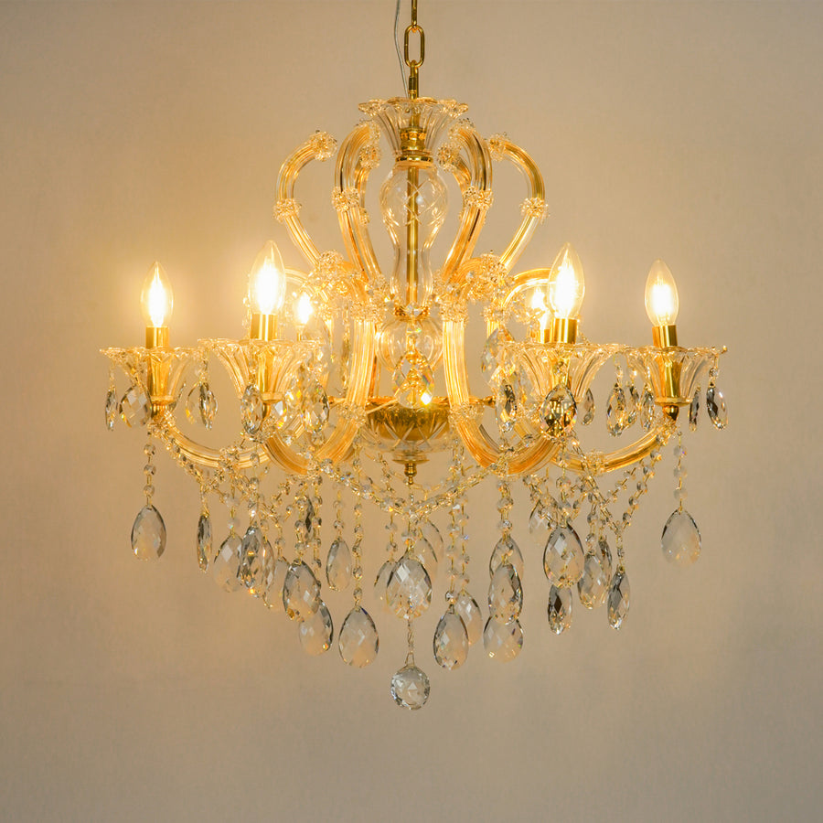 White background image of gold metal candle style chandelier for modern living room decor styling with a bright warm glow.