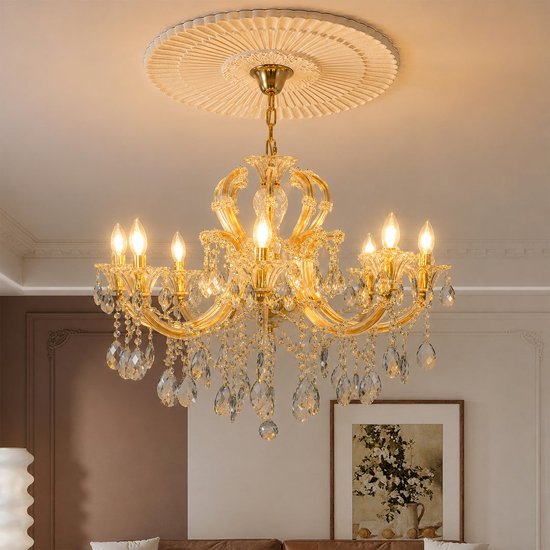 Lifestyle image of large gold metal candle style chandelier for luxury dining room decor styling with crystal detailings.