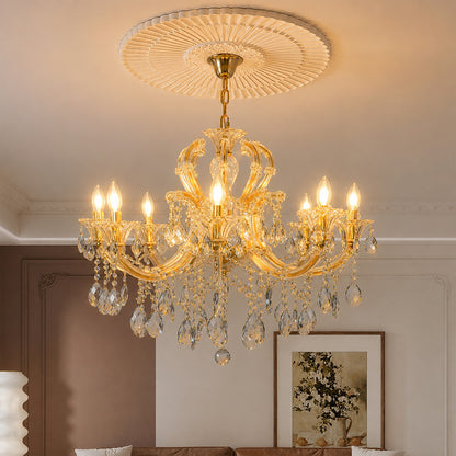 Lifestyle image of large gold metal candle style chandelier for luxury dining room decor styling with crystal detailings.