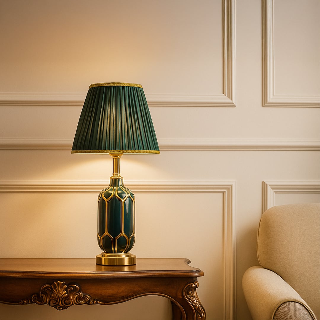 Sophisticated table lamp with an emerald patterned ceramic base metal accents and a pleated green shade giving warm light for elegant living room decor.