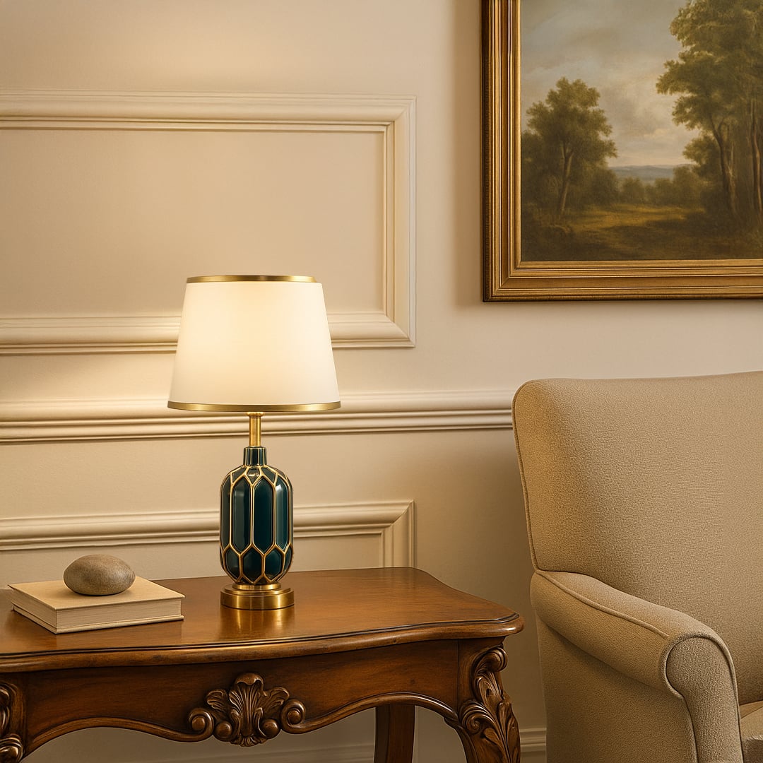 Table lamp with green and gold ceramic base and white shade styled on a classic console for elegant modern home decor.