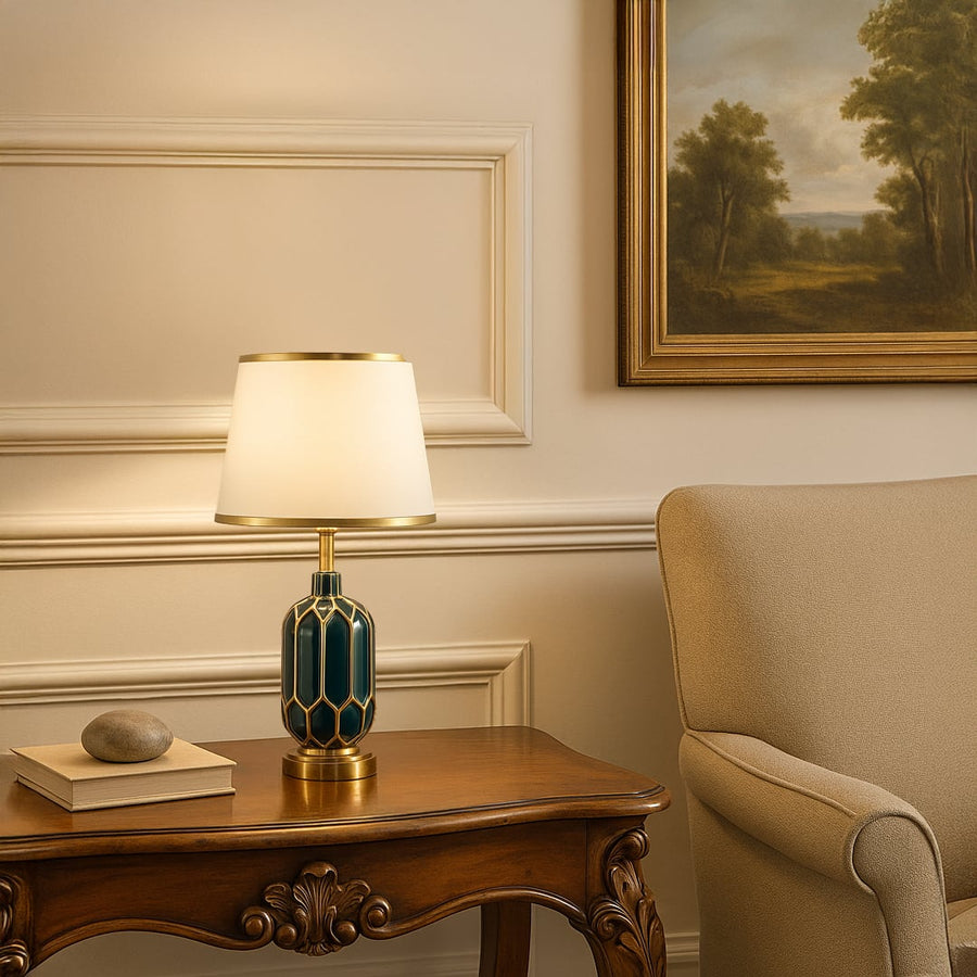 Table lamp with green and gold ceramic base and white shade styled on a classic console for elegant modern home decor.