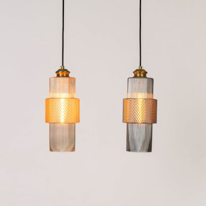 Pair of pendant lights with ribbed glass and brass finish glowing warmly on white background for ceiling lighting.