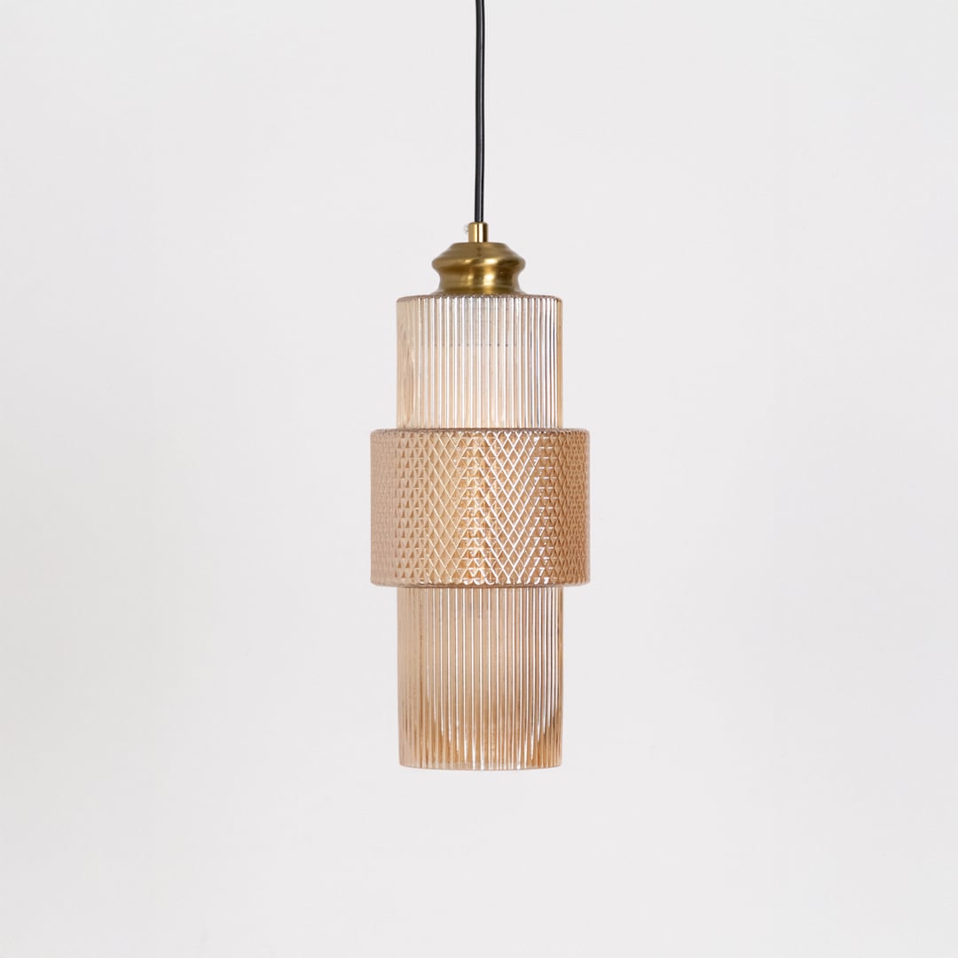 Pendant light with ribbed glass shade and brass top displayed off on white background for modern home decoration.