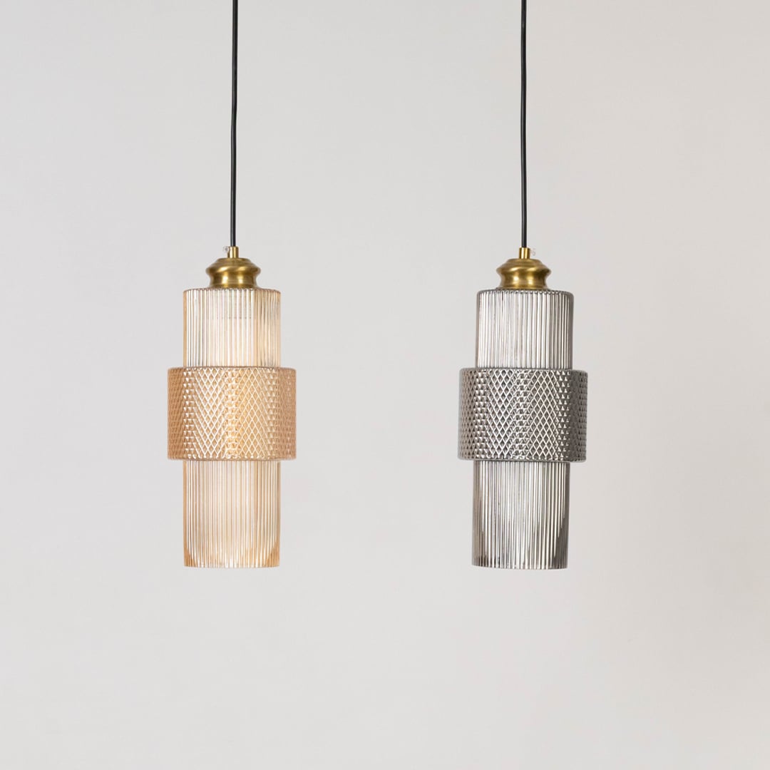 Two pendant lights with ribbed glass and brass finish shown switched off on white background for modern decor.
