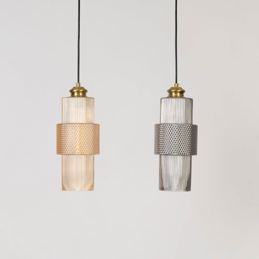 Two pendant lights with ribbed glass and brass finish shown switched off on white background for modern decor.