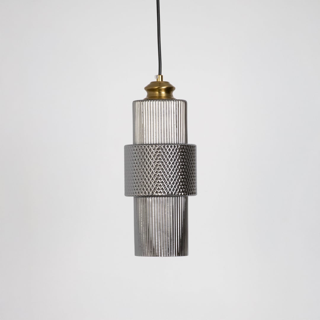 Pendant light with ribbed glass body and brass top shown off on white background for modern ceiling decoration.