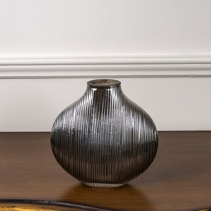 Smoky ribbed glass vase with rounded shape displayed on white background highlighting its reflective finish and elegant modern design.