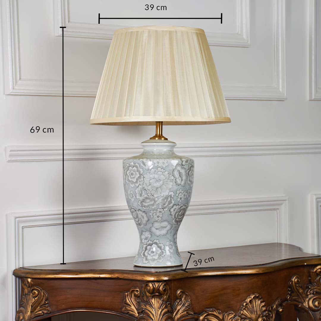 Ceramic table lamp with floral detailing shown with measurements of 69 cm height and 39 cm width displayed to illustrate accurate product sizing.