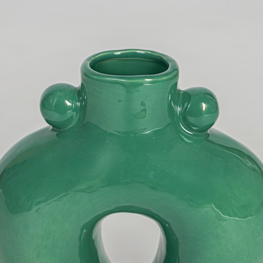 Closeup green textured ceramic vase surface detail modern decorative flower vase for table shelf console decor.
