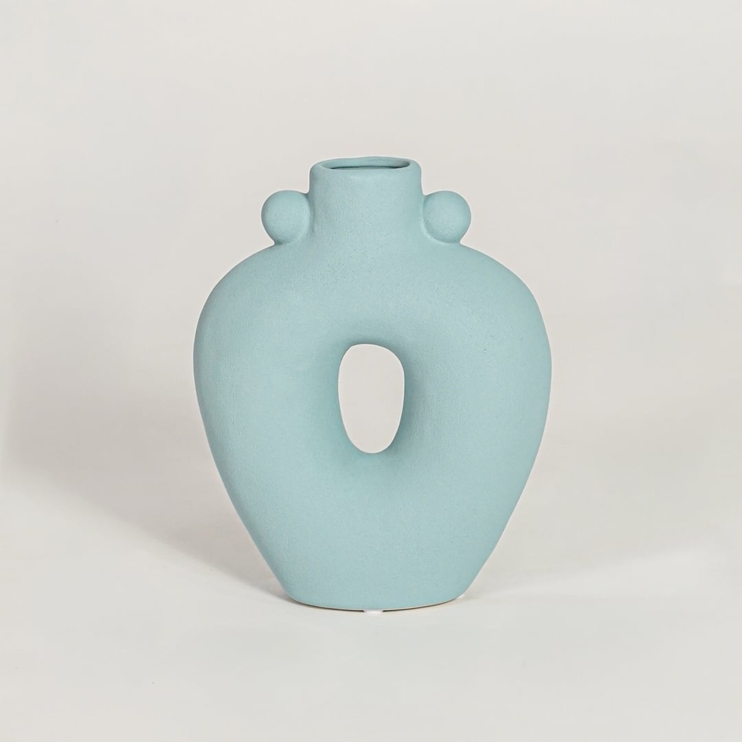 Contemporary light blue ceramic flower vase with abstract cutout shape perfect for entryway table living room decor display.