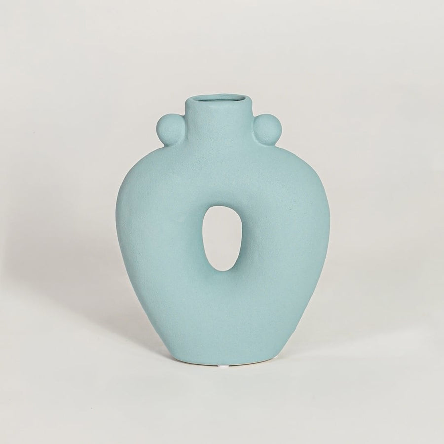Contemporary light blue ceramic flower vase with abstract cutout shape perfect for entryway table living room decor display.