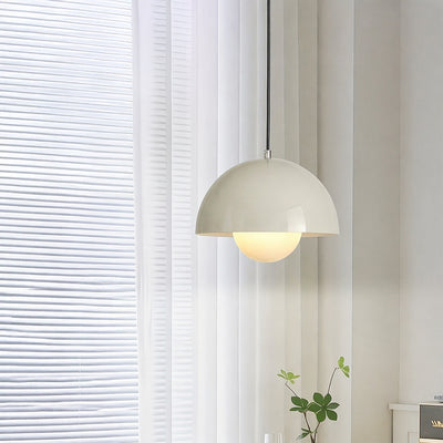 Cream metal pendant light with layered shade adding soft warmth to bright contemporary interiors.