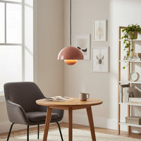 Peach metal pendant light with layered dome design enhancing home office decor with modern warmth.