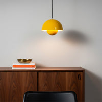 Mustard yellow metal pendant lights above dining table bringing warmth and contemporary appeal.