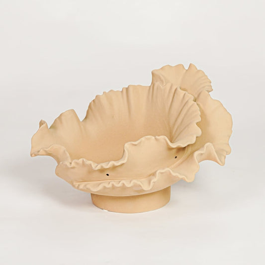 Beige ceramic ruffled decorative bowl with organic curved design isolated on white background for modern home decor display.