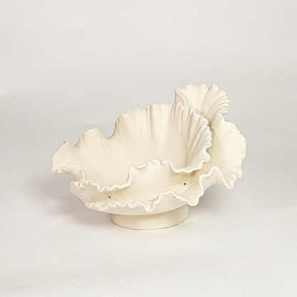 White ceramic ruffled decorative bowl with layered sculpted edges isolated on clean white background for elegant tabletop decor styling.