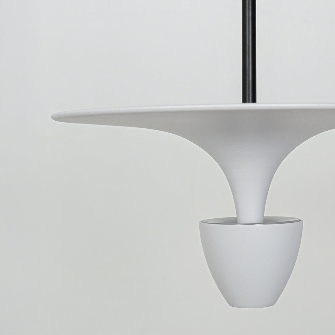 Closeup of white pendant light with minimal curved design for contemporary dining room decor inspiration.