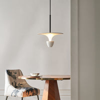 White and black metal pendant light above dining table bringing modern minimal style and ambient lighting indoors.