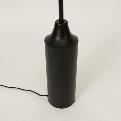Closeup of floor lamp shade and upper stem showing textured fabric finish smooth curves and premium craftsmanship under warm lighting.