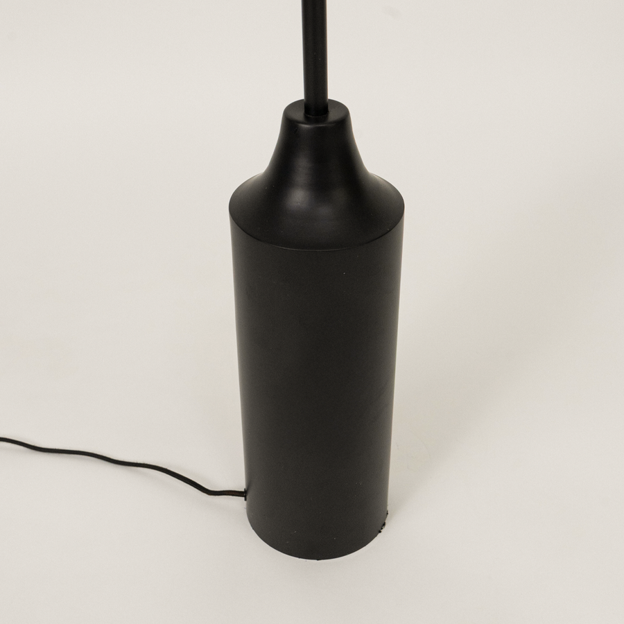 Closeup of floor lamp shade and upper stem showing textured fabric finish smooth curves and premium craftsmanship under warm lighting.