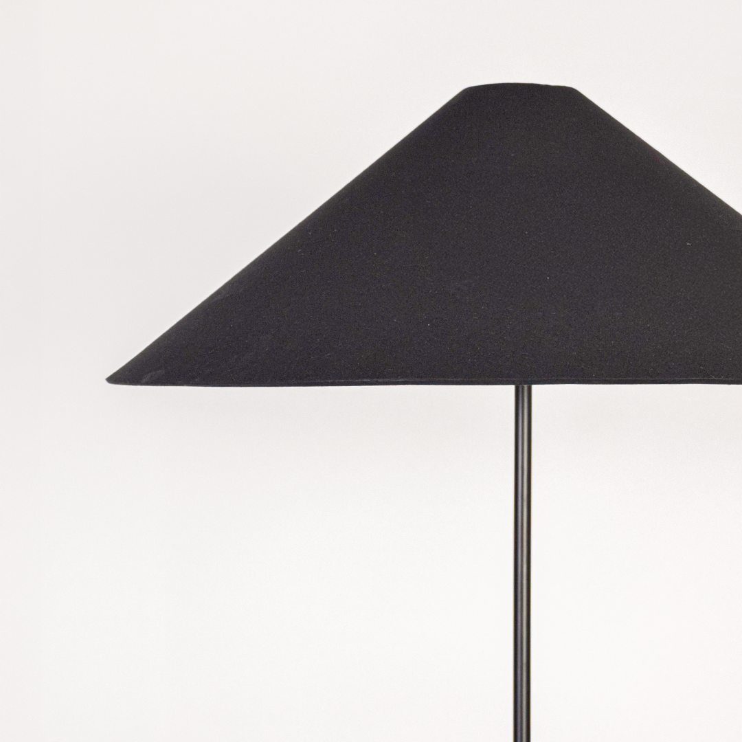 Closeup view of floor lamp base and stacked column design showing glossy surface gentle contours and refined build quality.