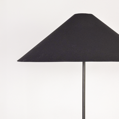 Closeup view of floor lamp base and stacked column design showing glossy surface gentle contours and refined build quality.