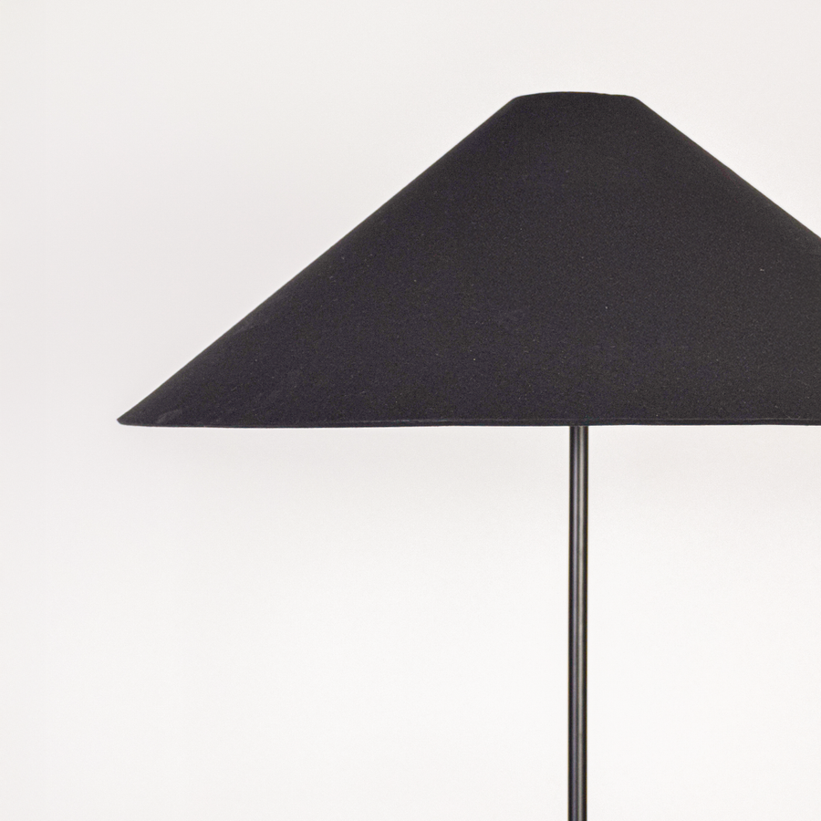 Closeup view of floor lamp base and stacked column design showing glossy surface gentle contours and refined build quality.