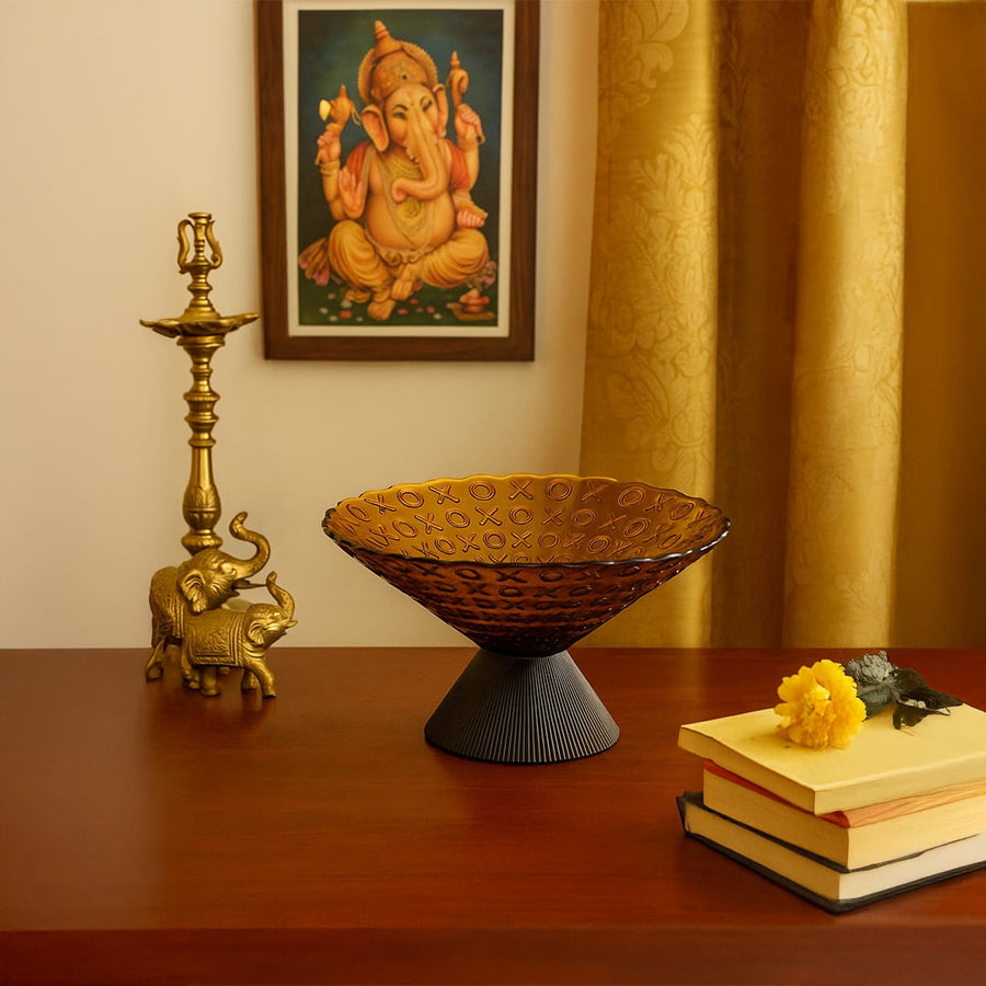 Amber glass decorative bowl with XO embossed texture styled on a modern table for a sophisticated and elegant home decor accent.