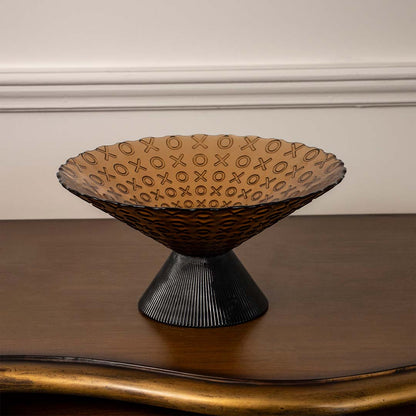 Amber decorative glass bowl with black ribbed pedestal base shown on white background for a clear minimalist product display.
