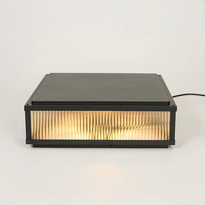 Minimal rectangular outdoor wall light with ribbed glass shade mounted on neutral wall background perfect for modern exterior decor lighting.