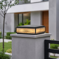 Modern black metal and glass outdoor gate light for entrance pillar garden fence and driveway with warm ambient lighting.