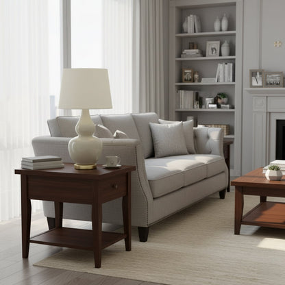 White shade ceramic table lamp on wooden side table with light off beside grey sofa for modern cozy living room décor.