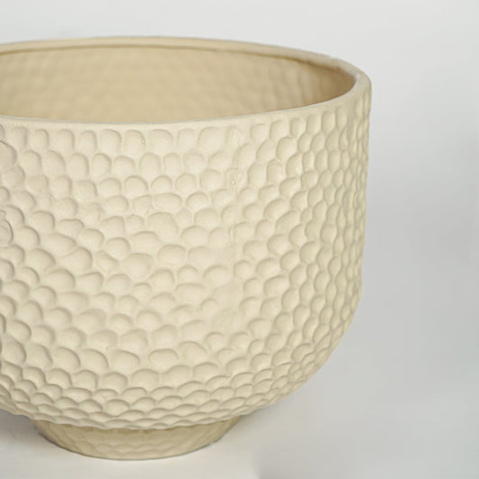 Close view of green ribbed ceramic vase showing twin tube structure and matte texture finish.