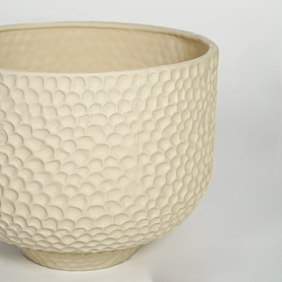 Close view of green ribbed ceramic vase showing twin tube structure and matte texture finish.