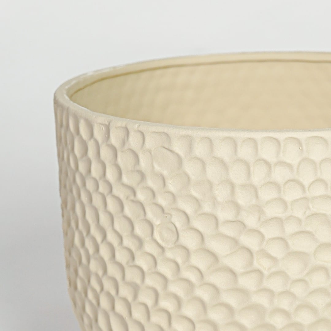 Detail of sculpted green ceramic vase opening and vertical ribbed surface for modern interior decor.