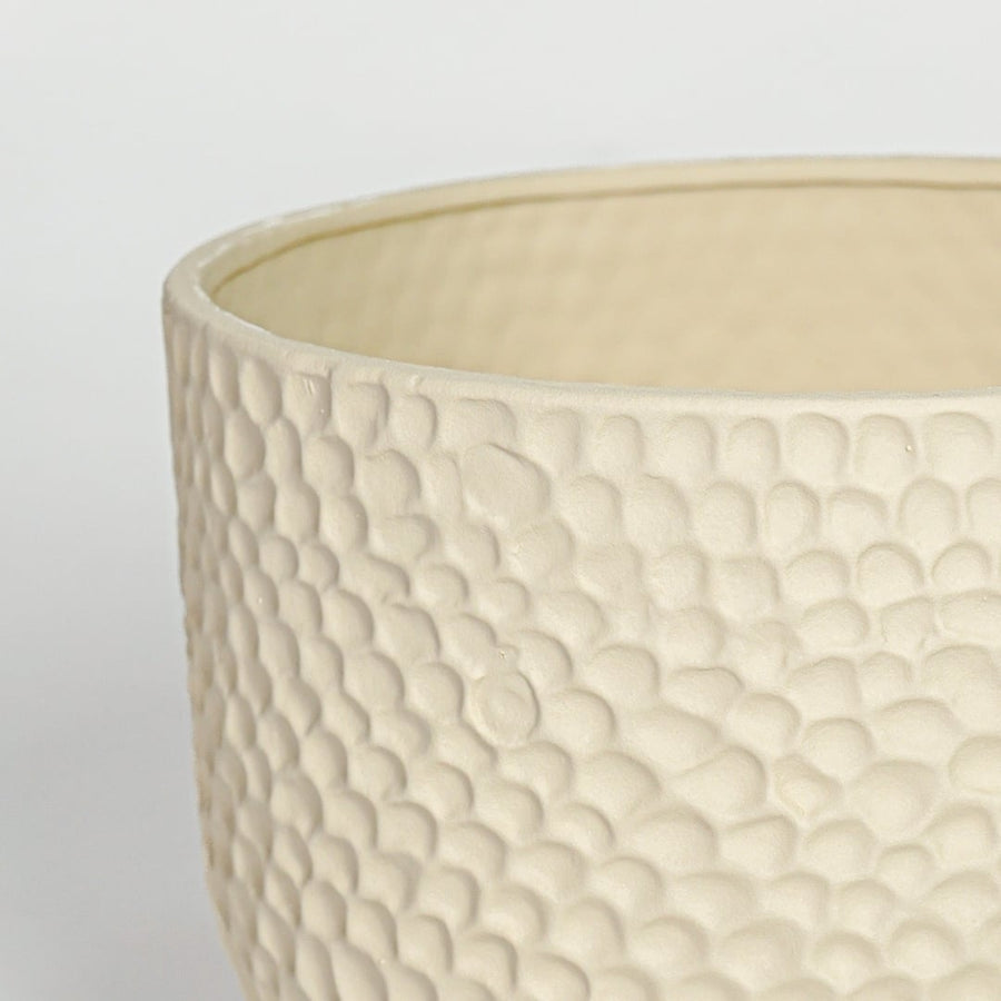 Detail of sculpted green ceramic vase opening and vertical ribbed surface for modern interior decor.