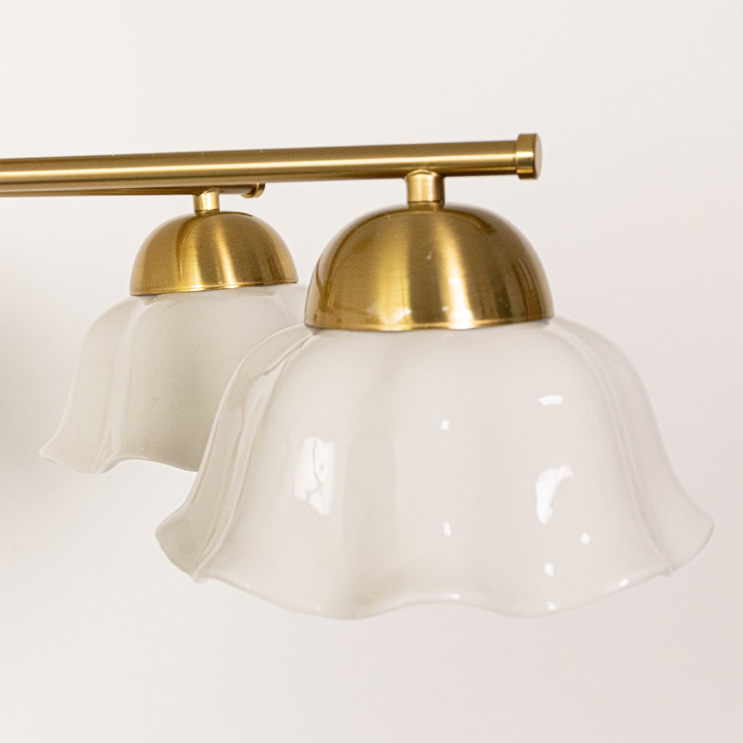Closeup view of metal ceiling light with sculpted white flower shaped shades showcasing its refined detailing and premium home decor appeal.