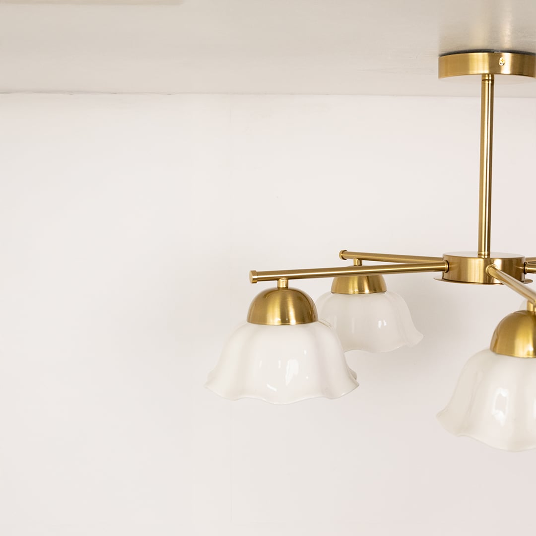 Detailed closeup of metal ceiling light highlighting the white petal shade texture and premium finish for stylish interior lighting.