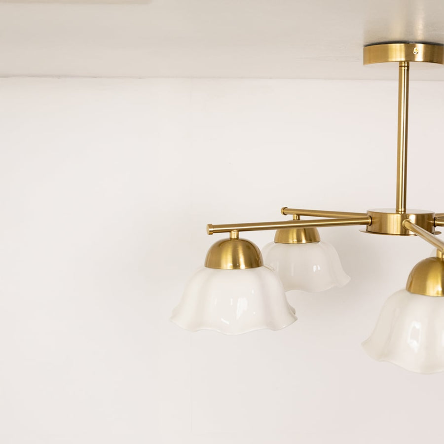 Detailed closeup of metal ceiling light highlighting the white petal shade texture and premium finish for stylish interior lighting.