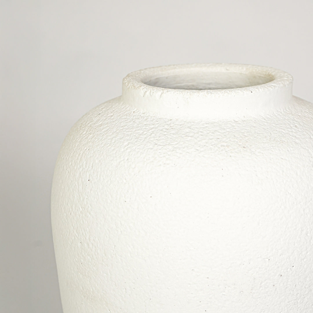 Closeup image of white ceramic decorative vase for elegant tabletop decor styling with rustic matte finish.
