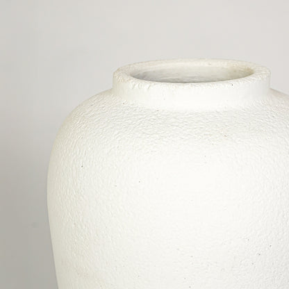 Closeup image of white ceramic decorative vase for elegant tabletop decor styling with rustic matte finish.