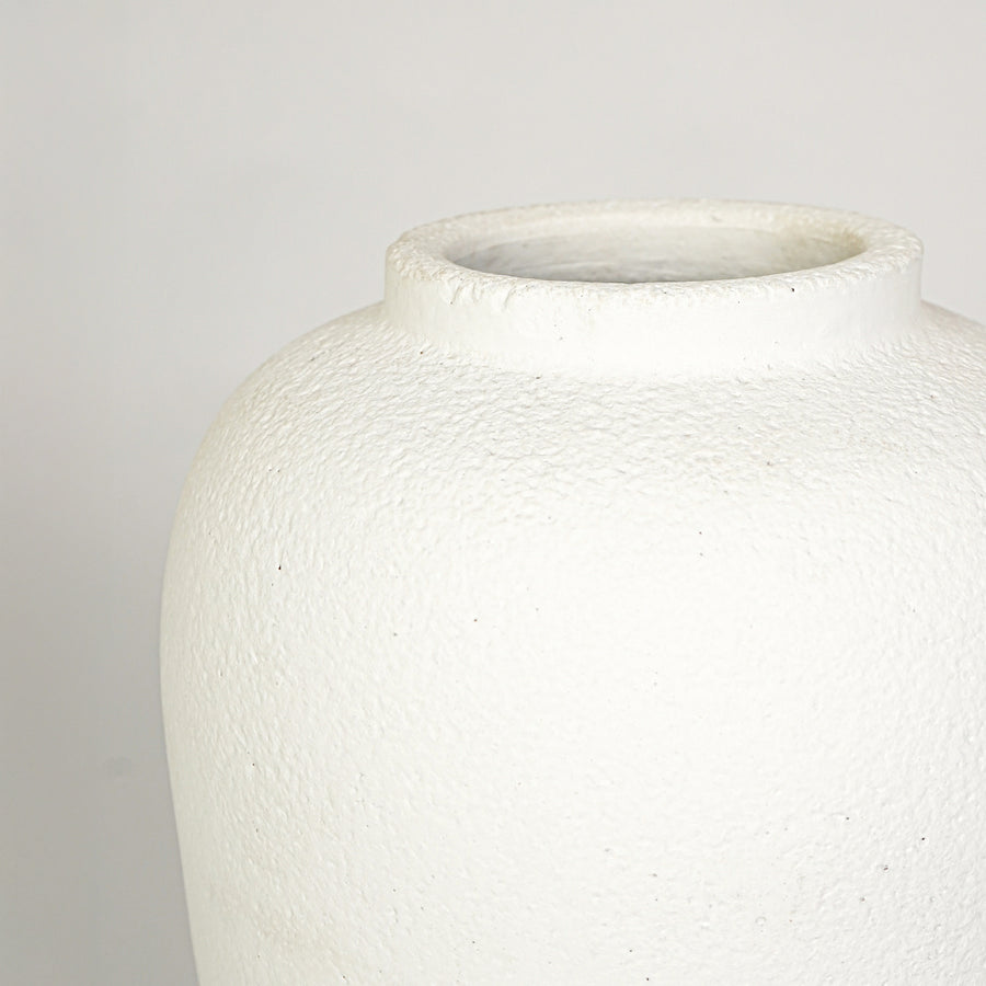 Closeup image of white ceramic decorative vase for elegant tabletop decor styling with rustic matte finish.