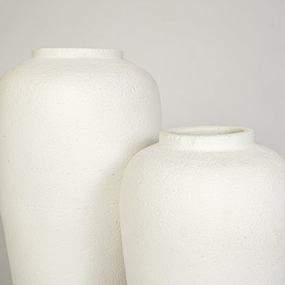 Closeup image of white ceramic vase set for modern interior decor styling with textured matte finish.