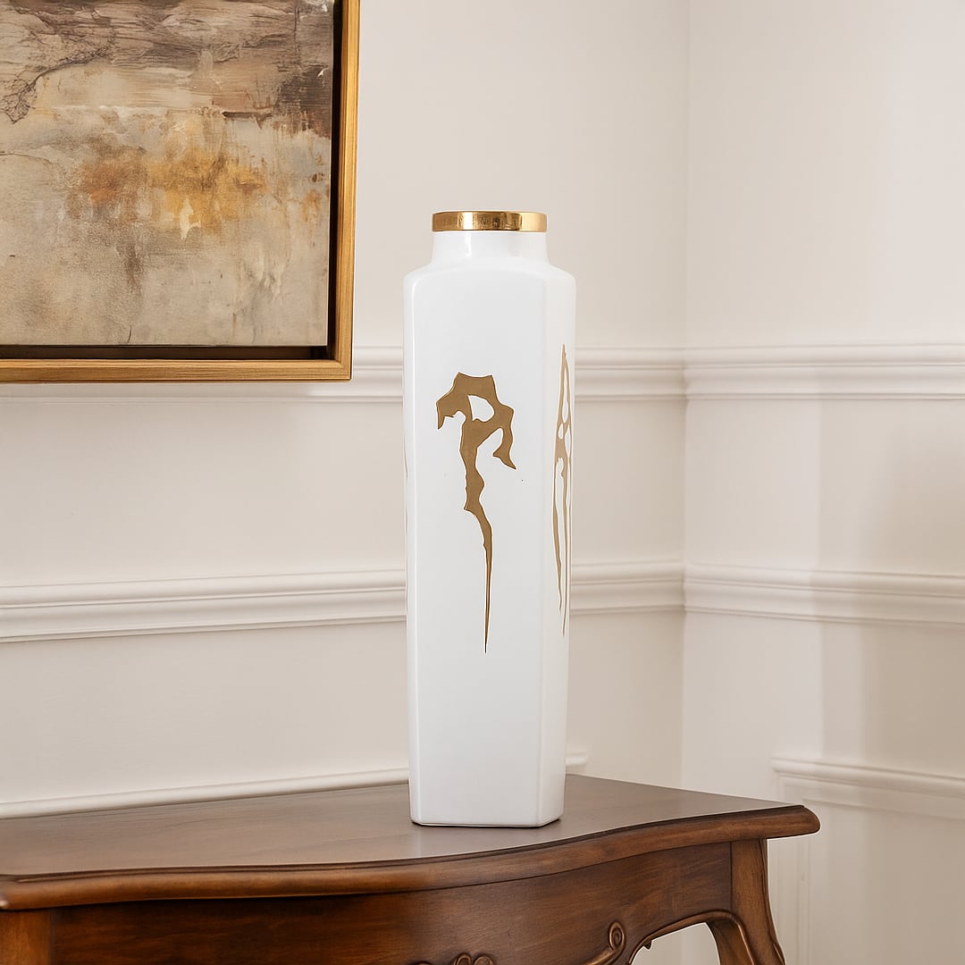White ceramic jar with elegant gold ribbon artwork perfect for luxury living room décor and stylish tabletop placement.