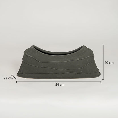Black ceramic decorative serving bowl showing 54 cm length 22 cm width and 20 cm height ideal for dining table centerpiece decor.