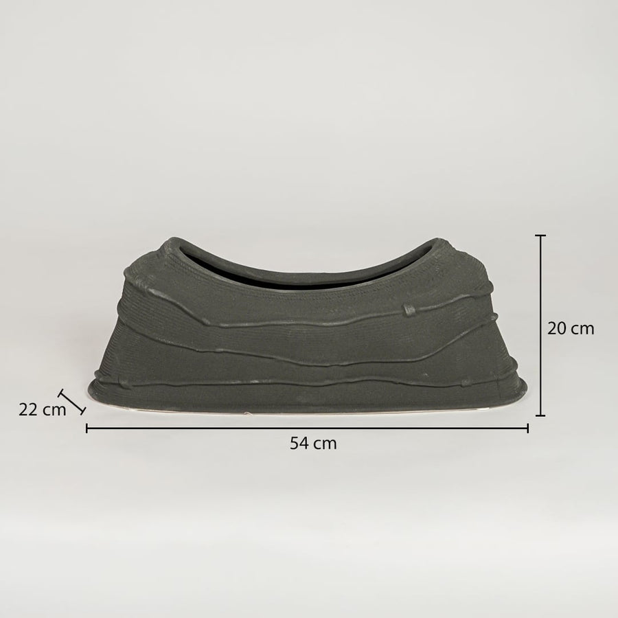 Black ceramic decorative serving bowl showing 54 cm length 22 cm width and 20 cm height ideal for dining table centerpiece decor.