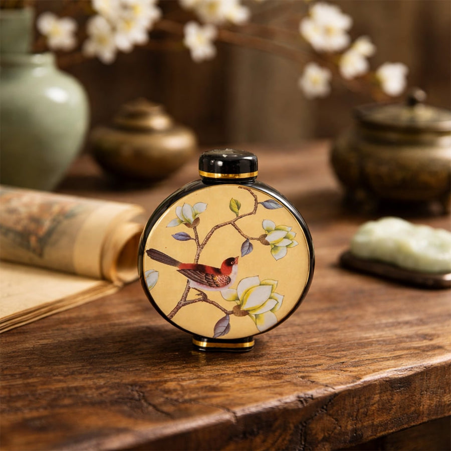 Round ceramic decorative jar with bird artwork styled on a wooden table for elegant modern home decor settings.