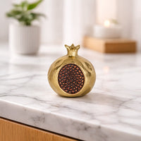 Gold metal decorative candle holder lifestyle image on marble countertop for elegant festive table decor.