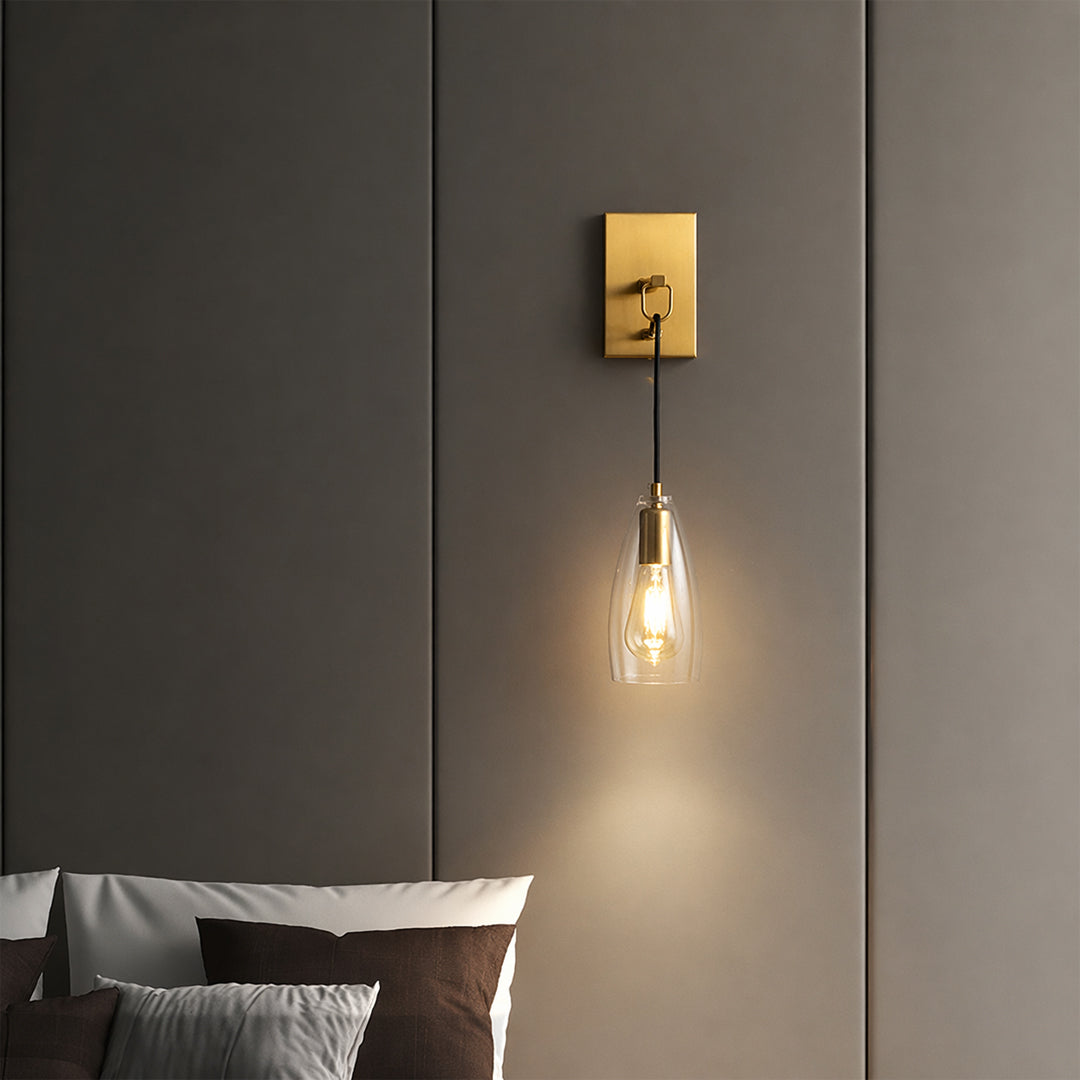 Modern gold metal hanging wall light with warm glow for elegant bedroom and luxury decor styling spaces.